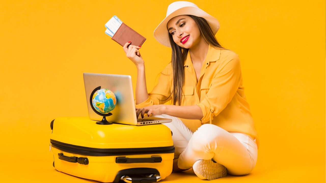 Woman dressed in yellow browsing website to buy travel insurance