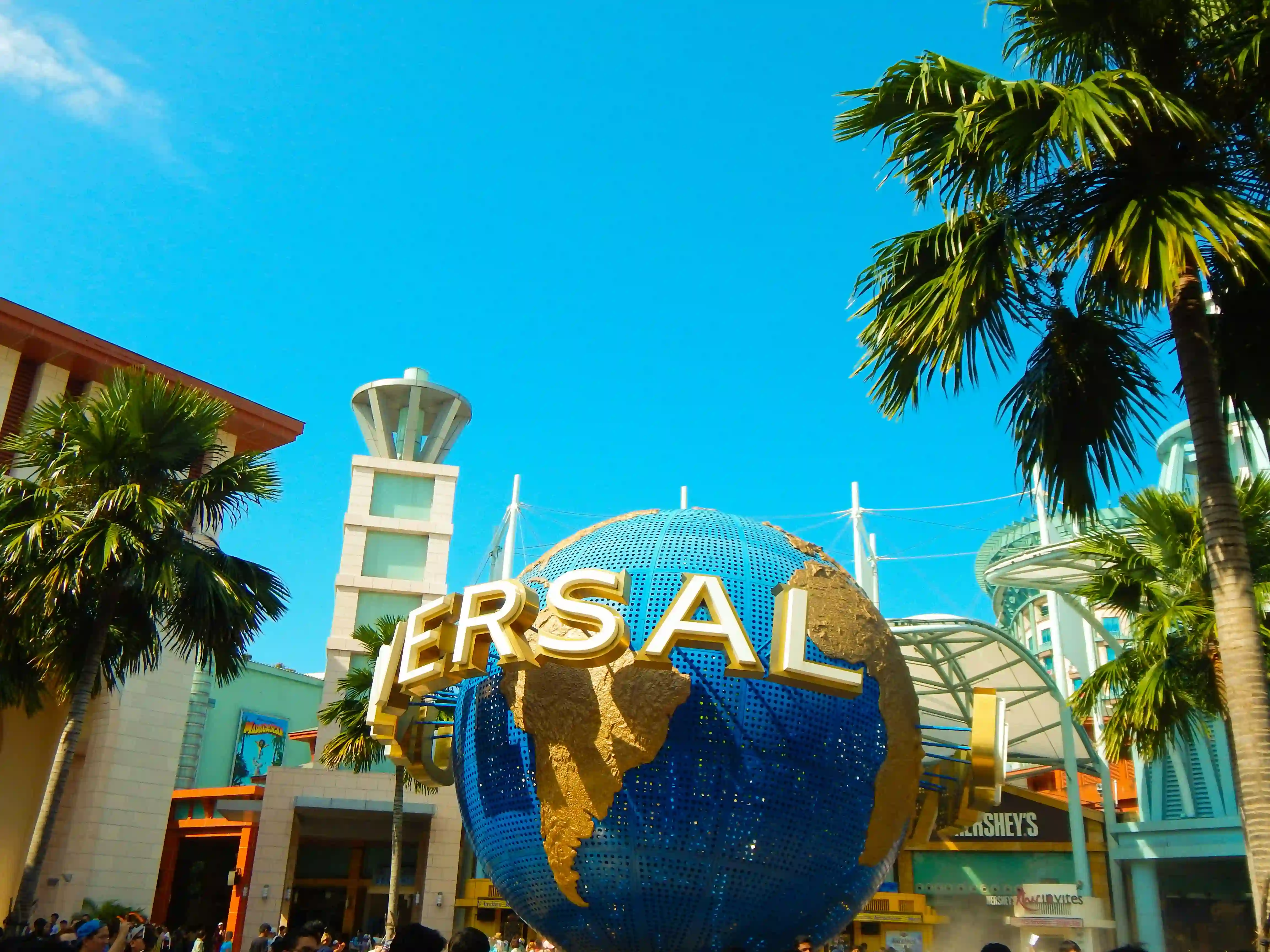 a-large-blue-and-gold-globe-in-front-of-a-building