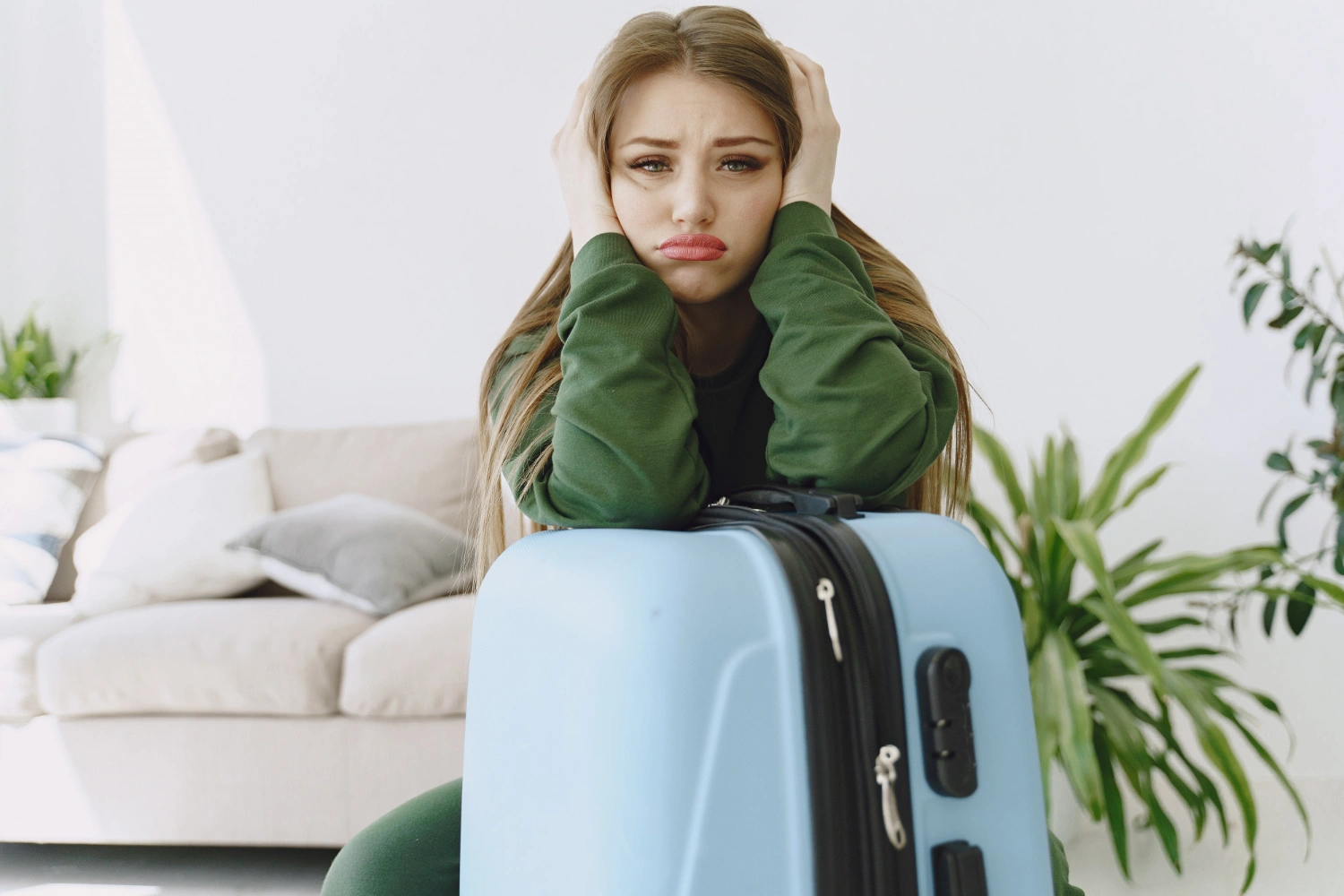 woman-with-luggage-staring-at-camera-anxiously